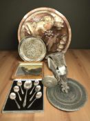 A group of metal wares including chargers, welded metal figure of dragon's head, cutlery,
