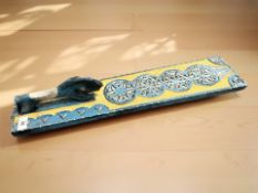 A decorative continental carved and painted pine mangle board.