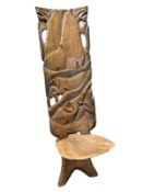 An African carved hardwood birthing chair.