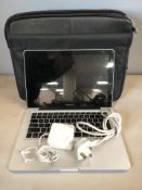 An Apple Macbook Pro serial No. W80090NY66D, with charging lead and a carry bag.