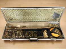 A gun case containing a cartridge belt, gun cleaning rods,