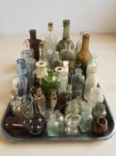 A collection of antique glass bottles, chemist's bottles, two stoneware examples.