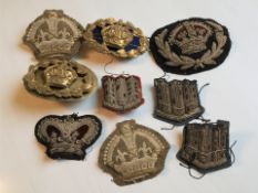 A small group of military cloth insignia and badges.