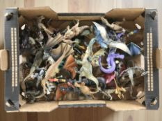 A collection of dinosaur and dragon toys / figurines.