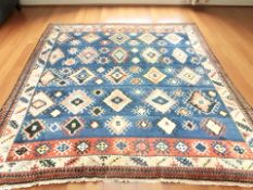 A large woollen carpet of Caucasian Kazak design, 467 cm x 413 cm.