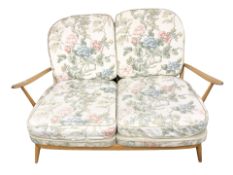 An Ercol light elm two seater spindle back lounge settee, width 136 cm.