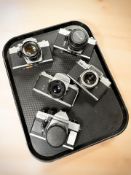 Praktica Super TL3, MTL 5B and LLC 35mm film camera bodies, two with Asahi lenses,