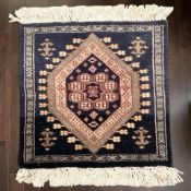 A small Iranian rug, 40 cm x 38 cm.