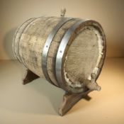 A coopered oak keg on stand, length 40 cm.