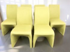 A set of six contemporary dining chairs in lime green fabric.