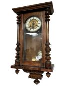 A walnut Vienna wall clock with enameled dial, height 63 cm.
