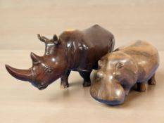 A carved hardwood rhinoceros, length 56 cm, and a similar hippo.