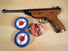 A West Lake .177 calibre air pistol with two tins containing pellets.