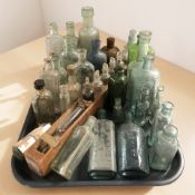 A collection of antique glass bottles, chemist's bottles.