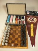 A games compendium and a chess board with a set of resin chess pieces