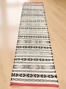 A Kilim runner, 282 cm x 79 cm.