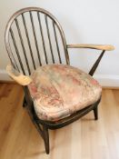 An Ercol stained elm armchair, width 66 cm.