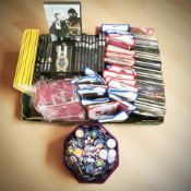 A quantity of CDs, James Bond Spectre DVDs, new mobile phone cases, lapel badges, etc.