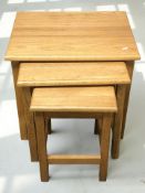A reproduction oak nest of three tables, width 54 cm.