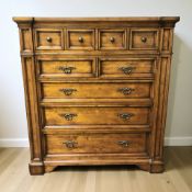 A Barker & Stonehouse stained pine nine drawer chest, 123 cm x 54 cm x 134 cm.