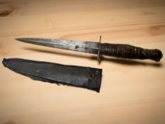 A Fairbairn Sykes-style fighting knife in sheath.