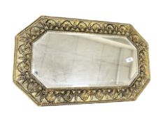 An early 20th century brass embossed bevelled mirror,