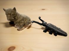 A gilt plaster figure of a terrier and a cast iron beetle boot jack.