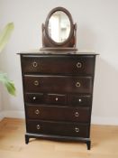 A Stag Minstrel seven drawer chest, 82 cm x 47 cm x 113 cm, together with an oval swing mirror.