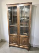 An early 20th century double door glazed oak bookcase, with key, 80 cm x 27 cm x 154 cm.