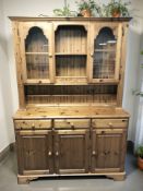 A reproduction pine kitchen dresser, 133 cm x 45 cm x 190 cm.
