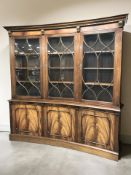 A Bevan Funnel Reprodux inverted bow front triple door glazed mahogany bookcase,