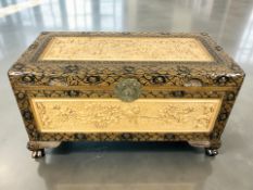 An oriental heavily carved and lacquered camphor wood blanket chest, 90 cm x 45 cm x 49 cm.