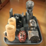 A pair of carved ebony bookends in the form of elephants, together with two African hardwood busts,