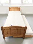 A 3 ft pine truckle bed, with pullout mattress beneath.