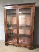 A late Victorian glazed mahogany double door bookcase, with key, 128 cm x 34 cm x 175 cm.