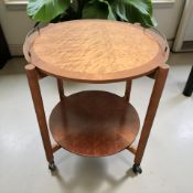 A reproduction yew wood circular trolley, diameter 65 cm.