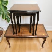 A reproduction inlaid mahogany nest of three tables and a further similar coffee table.