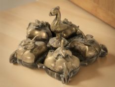 An unusual oriental brass five compartment vessel surmounted by a bird, diameter 11 cm.