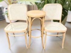 A bentwood occasional table and a pair of caned chairs.
