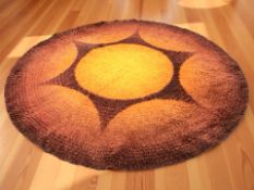 A 1970's sunburst pattern circular shaggy piled rug, diameter 240 cm.