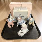 A boxed Lladro figure of a clown with a puppy No. 5278, two boxed Nao figures No.