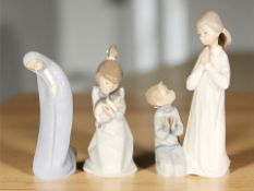 A Lladro figure group of a girl and boy praying, No. 4779, together with two further Lladro figures.