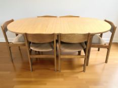 A 20th century teak veneered oval extending dining table with leaf,