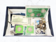 A group of coins, continental bank notes, US dollars, commemorative crowns.