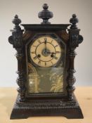 An early 20th century stained beech Junghans mantel clock, with pendulum, height 46 cm.