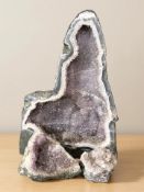 Three amethyst geode specimens, the largest 50 cm H x 35 cm W x 15 cm D.