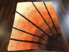 A 1970's shaggy piled rug depicting a sunset, 147 cm x 115 cm.