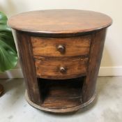 A contemporary oval hardwood occasional table fitted two drawers, width 62 cm.