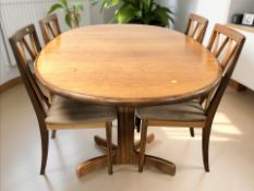 A teak G Plan oval extending dining table with internal leaf,
