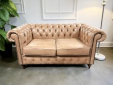 A contemporary Chesterfield two seater club settee in deep buttoned and studded tan leather,